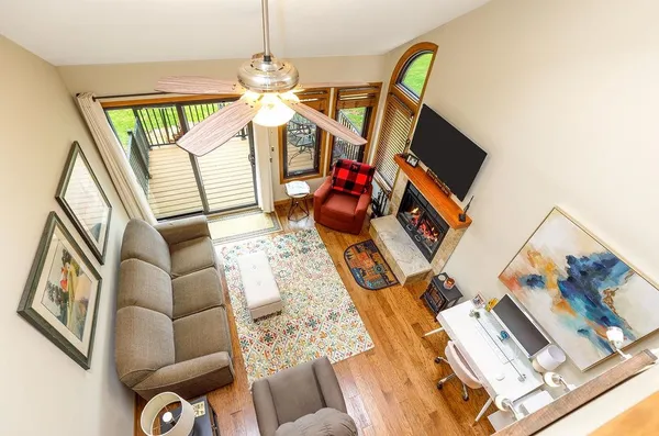 a living room with furniture a fireplace and a flat screen tv