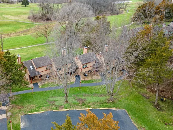 a view of a garden with lawn chairs