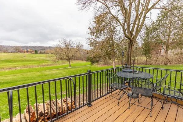 a view of a balcony with wooden floor and fence