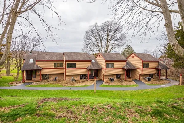 a view of a big yard with table and chairs under an umbrella