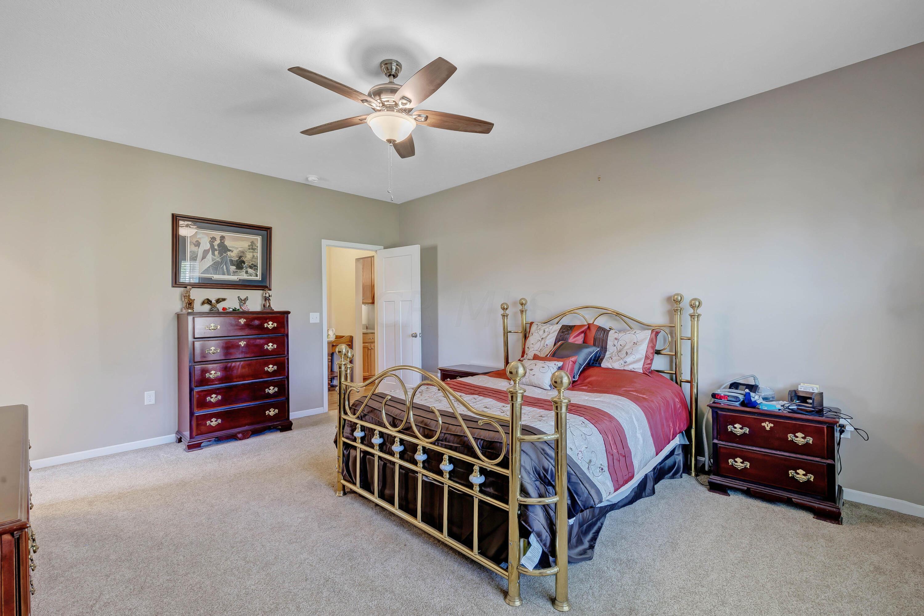 16347 Murphy Road Sunbury, OH 43074 - Photo 23 of 74 • Light sand carpet • Tan painted walls • Lighted ceiling fan • Window shutters