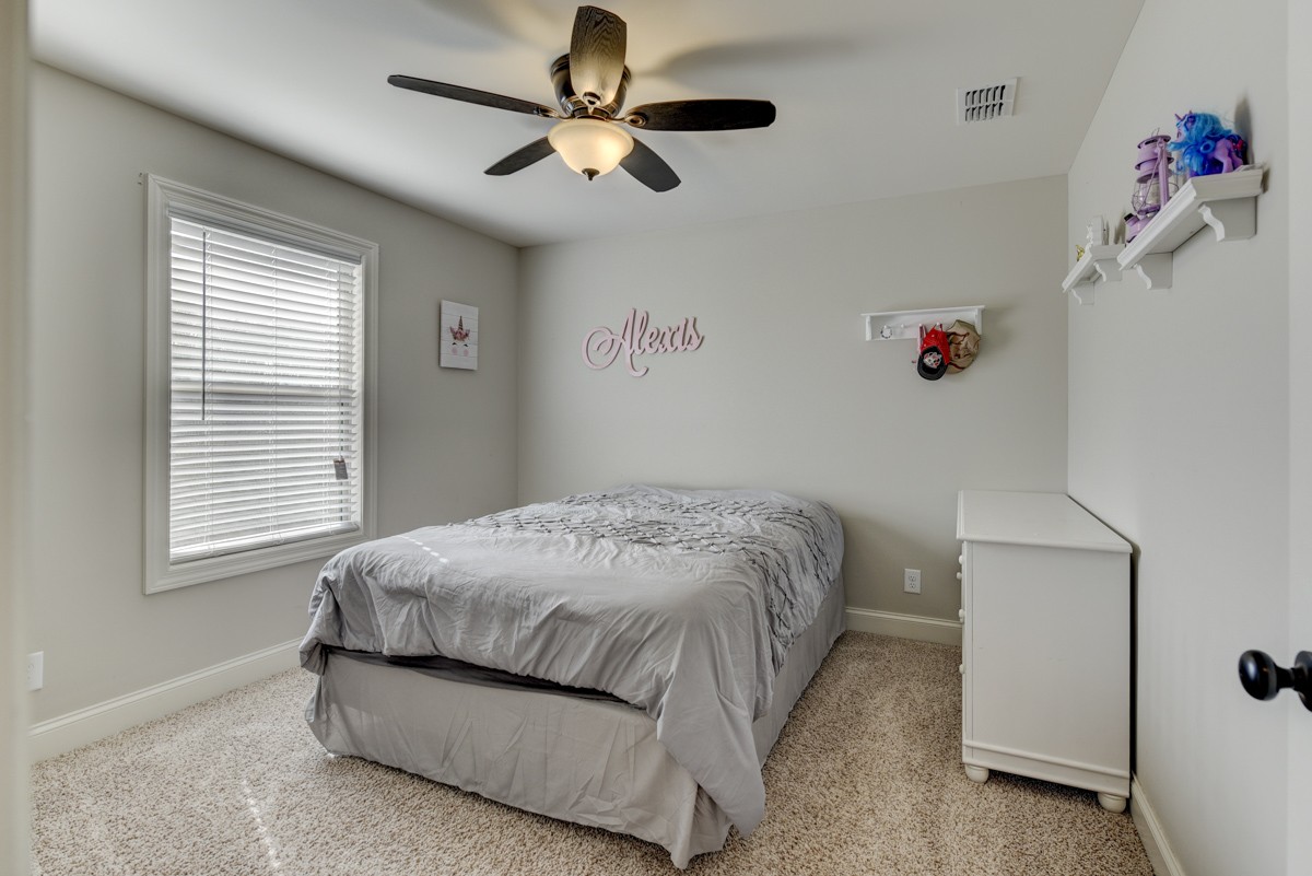 420 Bates Road Lebanon, TN 37087 - Photo 36 of 41 a bedroom with a bed and a chandelier