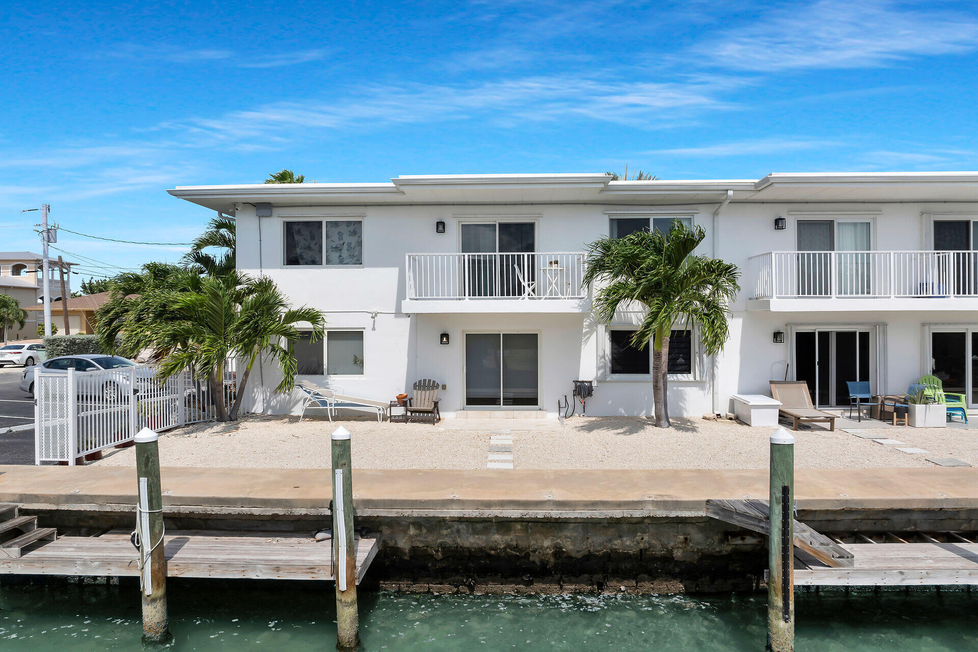 1215 97th Street, Unit 6 Marathon, FL 33050 - Photo 14 of 20 a view of a white house with swimming pool