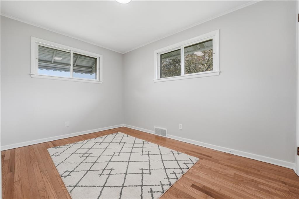 17 Shenango Road New Castle, PA 16105 - Photo 15 of 16 a view of an empty room with wooden floor and a window