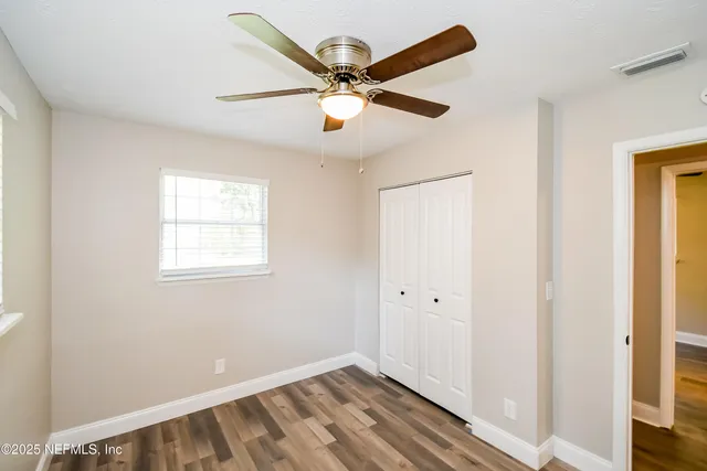 a view of room with window and ceiling fan