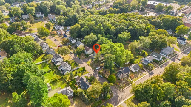 a view of a hallway with wooden floor and front door