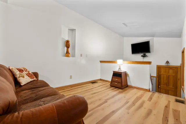 a view of a room with wooden floor and windows