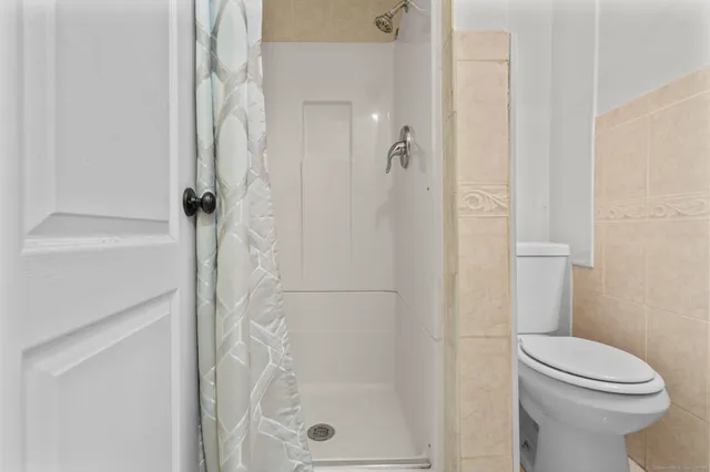 a bathroom with a toilet a sink and a window