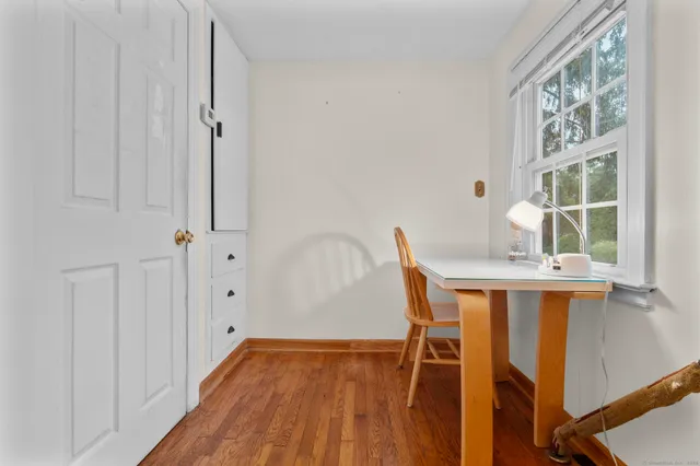 a bedroom with furniture and wooden floor