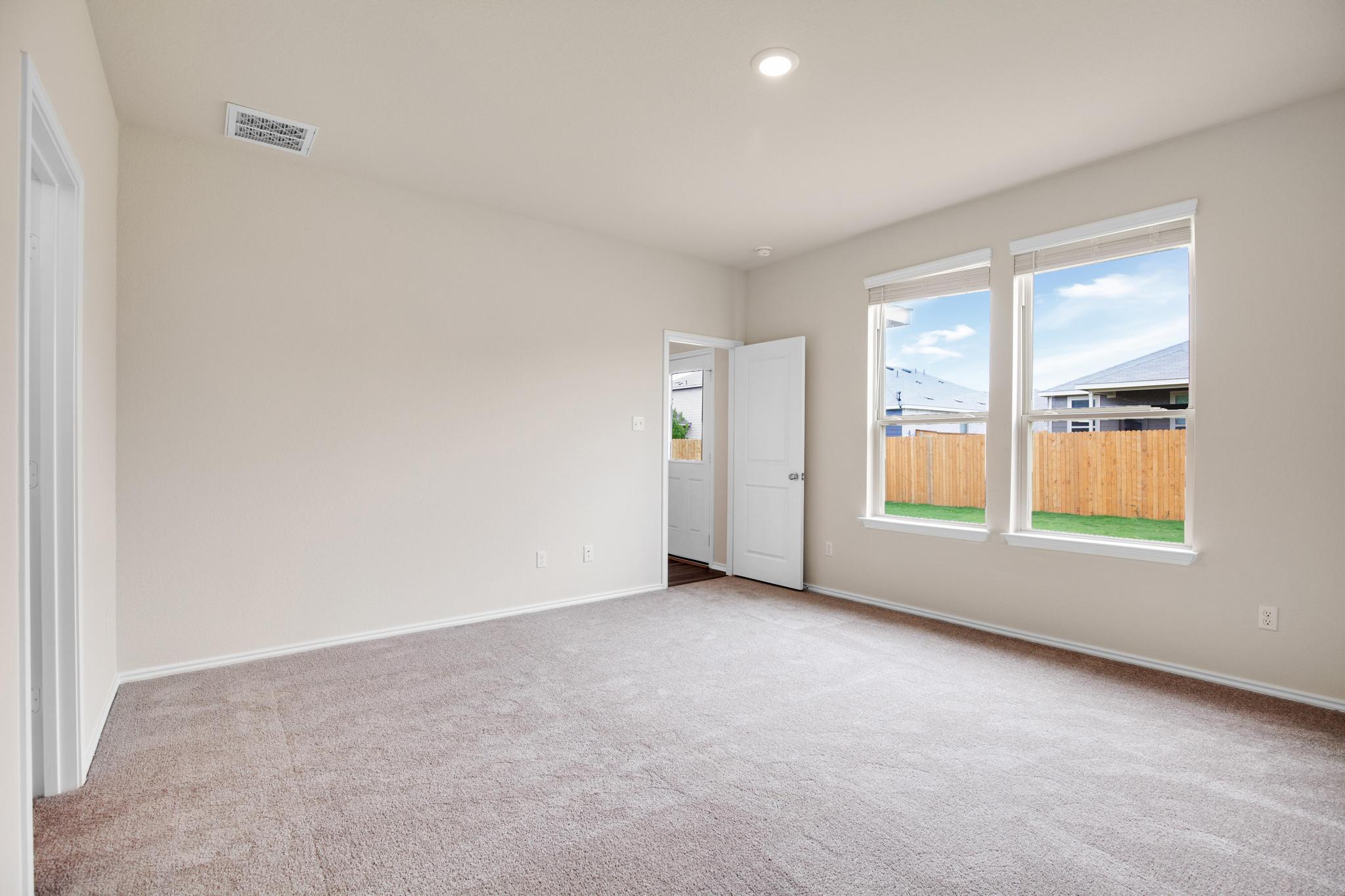 200 Janice Road Taylor, TX 76574 - Photo 11 of 25 A quiet bedroom with ample natural illumination from twin windows overlooking a fenced yard.