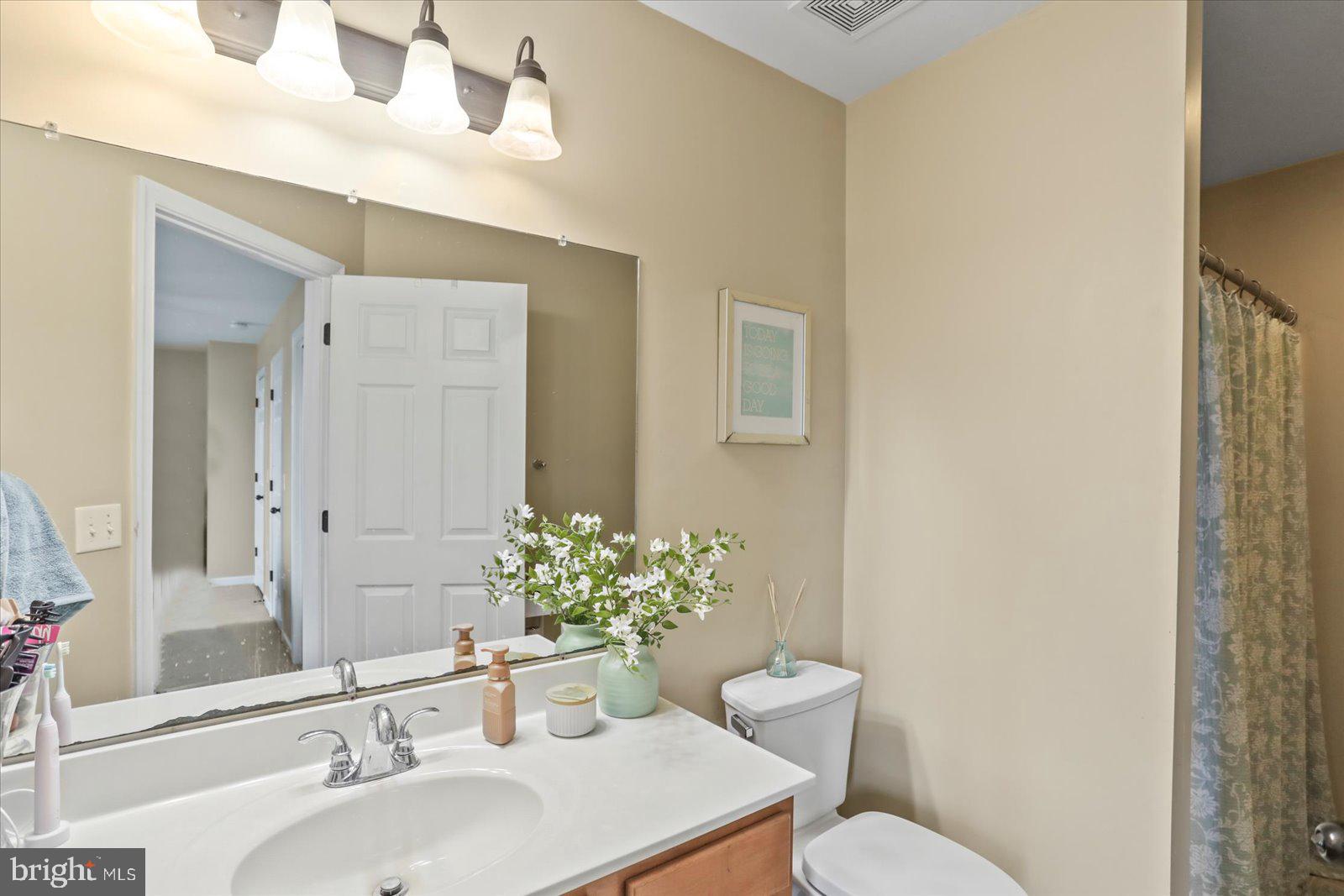 14 Galaxy Drive Hanover, PA 17331 - Photo 21 of 38 a bathroom with a sink mirror and toilet
