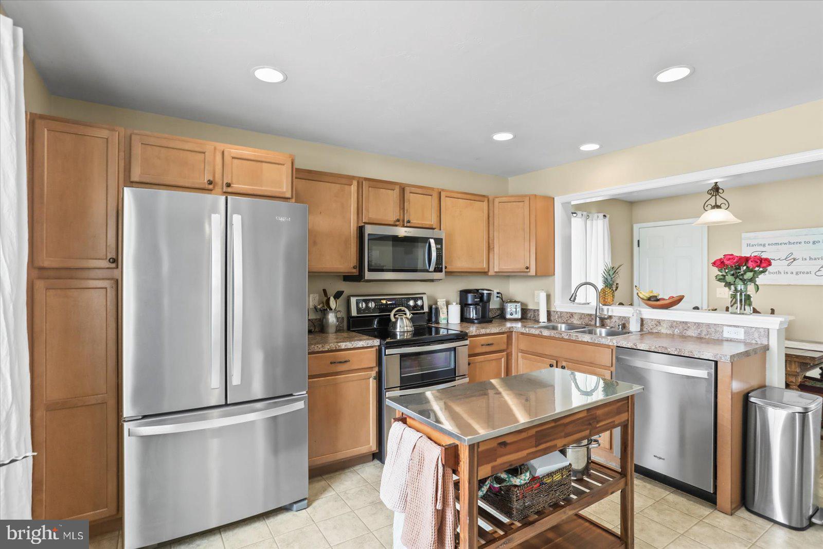 14 Galaxy Drive Hanover, PA 17331 - Photo 6 of 38 a kitchen with kitchen island white cabinets and stainless steel appliances