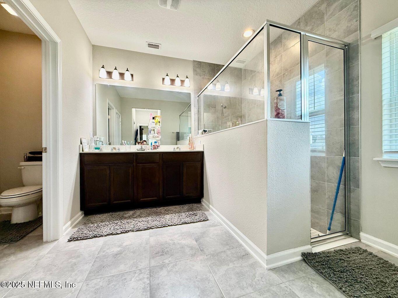 195 Torres Street St. Augustine, FL 32095 - Photo 13 of 22 a bathroom with a granite countertop sink and a mirror