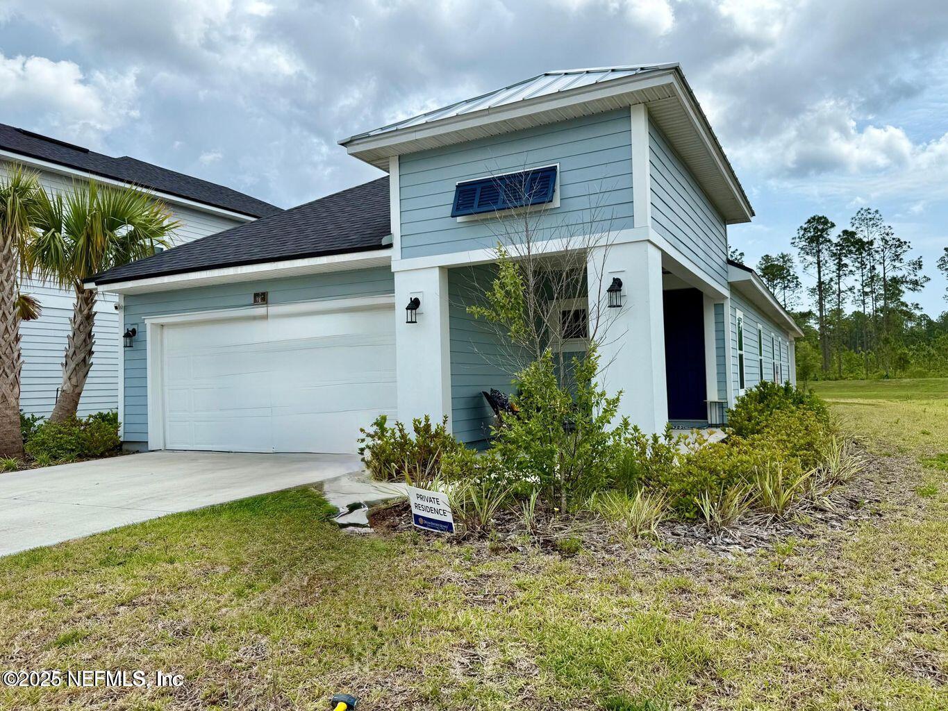 195 Torres Street St. Augustine, FL 32095 - Photo 2 of 22 a front view of a house with garden