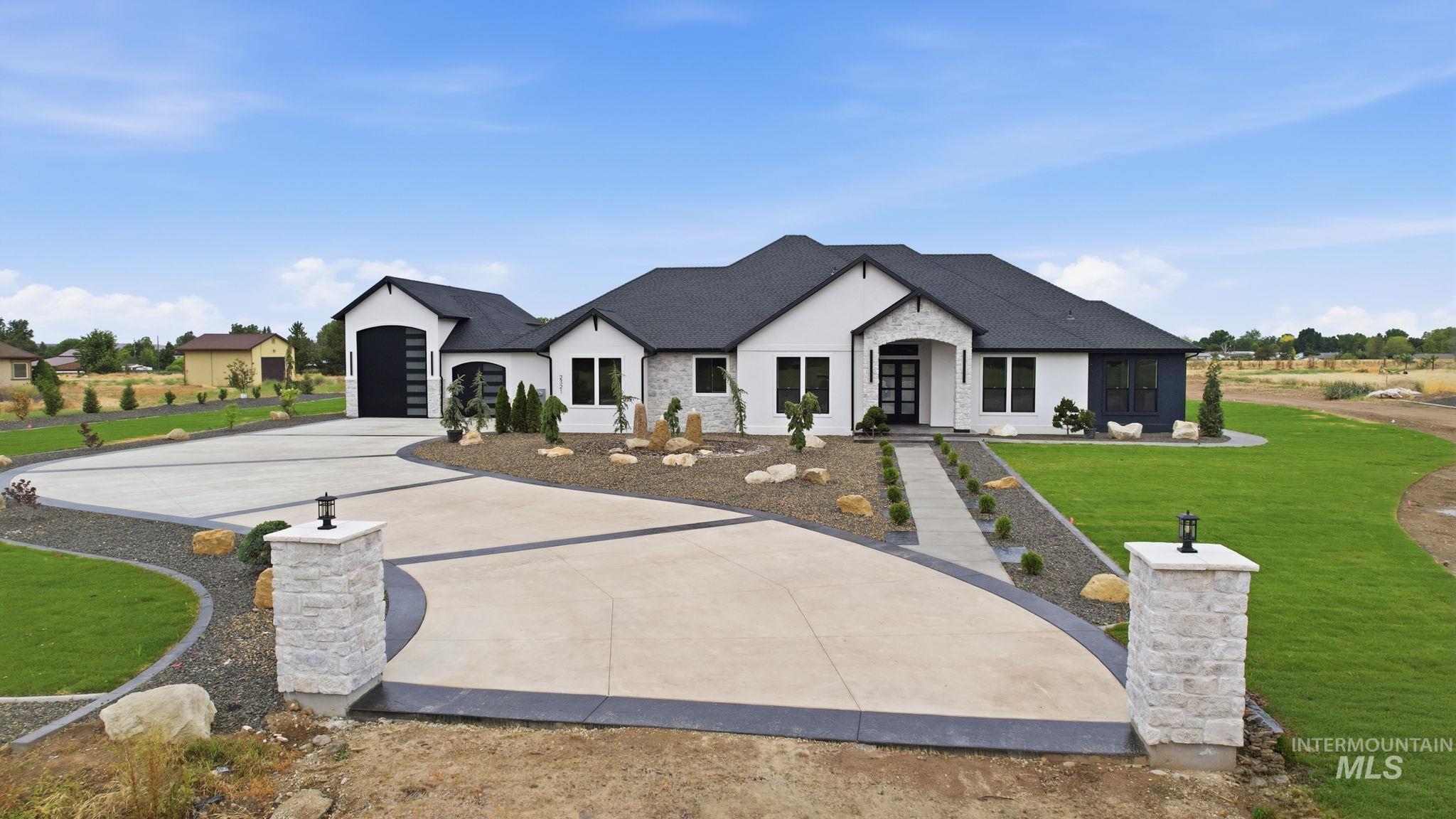 2321 Lower Bluff Road Emmett, ID 83617 - Photo 30 of 31 Expansive property featuring a modern single-story residence with a dark roof and white exterior