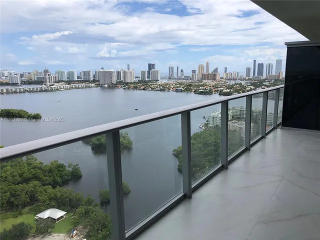 an aerial view of ocean and residential houses with outdoor space and lake view