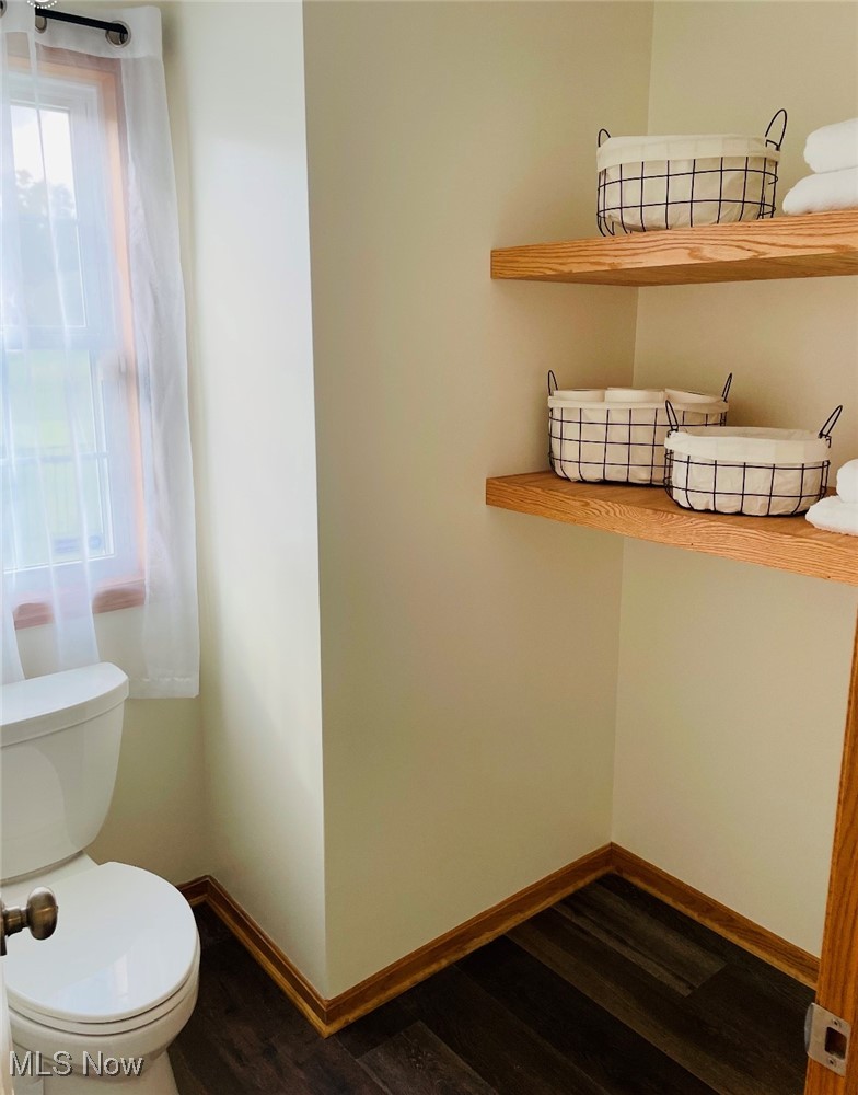 2435 Queensbury Road Alliance, OH 44601 - Photo 27 of 36 Half bathroom featuring dark wood finished floors and toilet