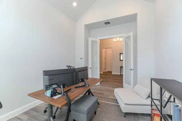 a living room with furniture and a wooden floor