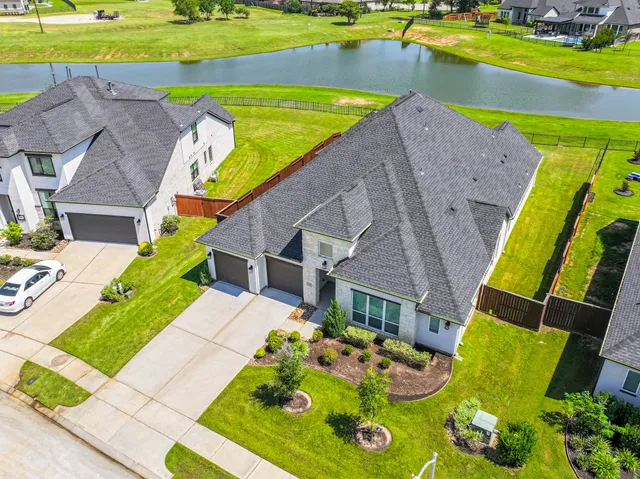 an aerial view of a house with a swimming pool