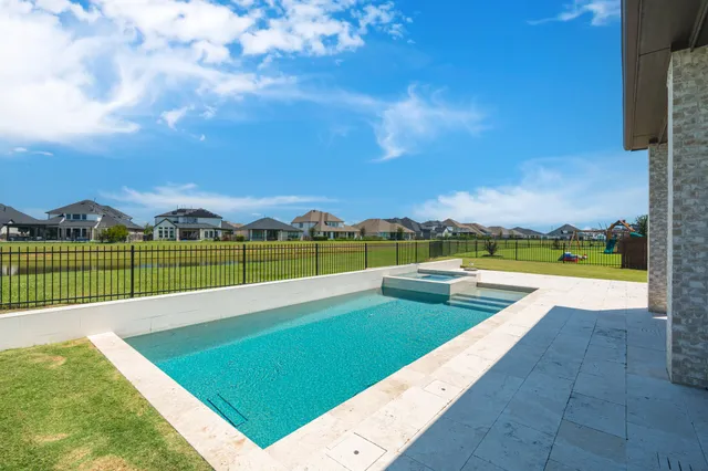 a view of a swimming pool and an outdoor seating