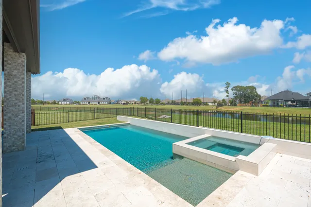 a view of a swimming pool and lounge in the terrace