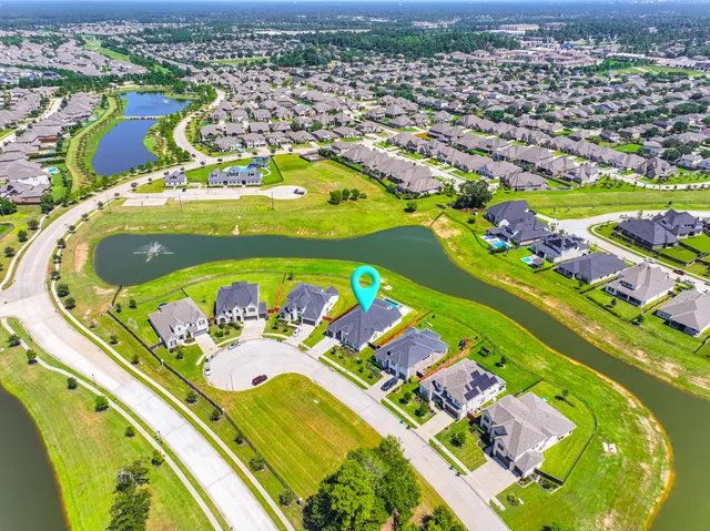 an aerial view of a swimming pool patio and mountain view in back