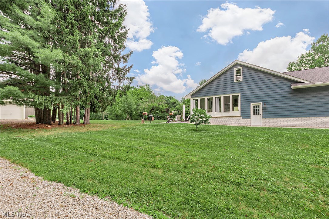 11292 Butternut Road Chardon, OH 44024 - Photo 37 of 49 Spacious rear yard with a gravel pathway and mature evergreen trees