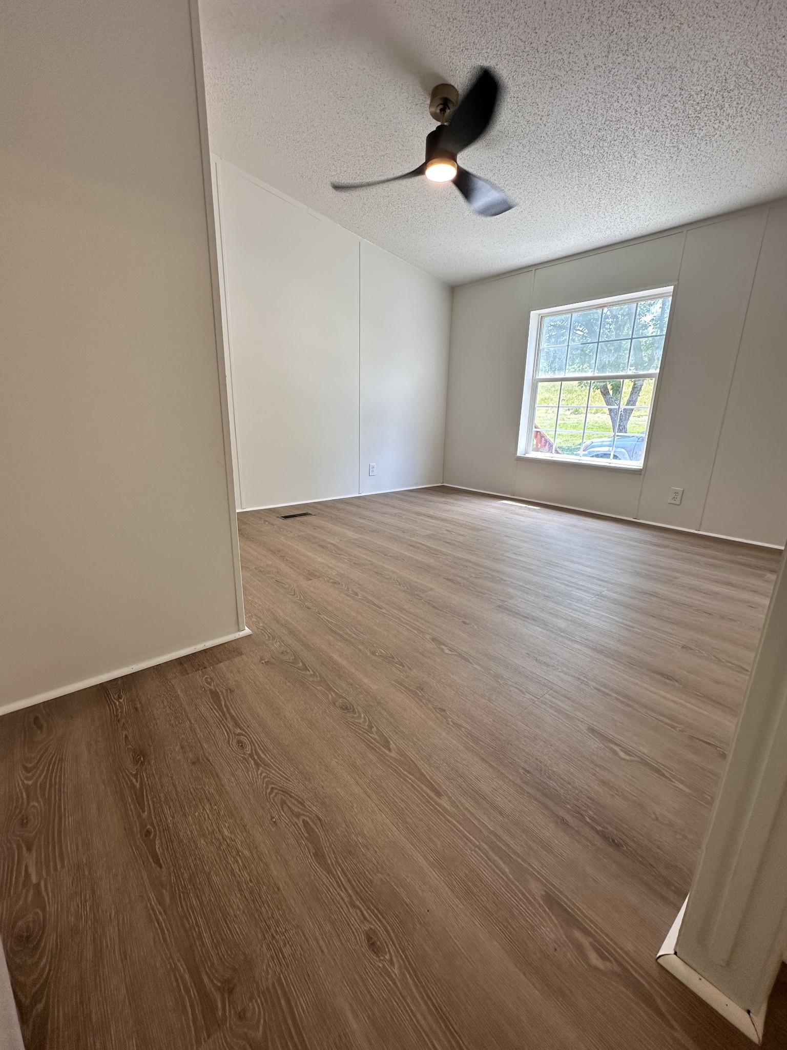 7287 Pinewood Road Nunnelly, TN 37137 - Photo 17 of 18 a view of an empty room with wooden floor and a window
