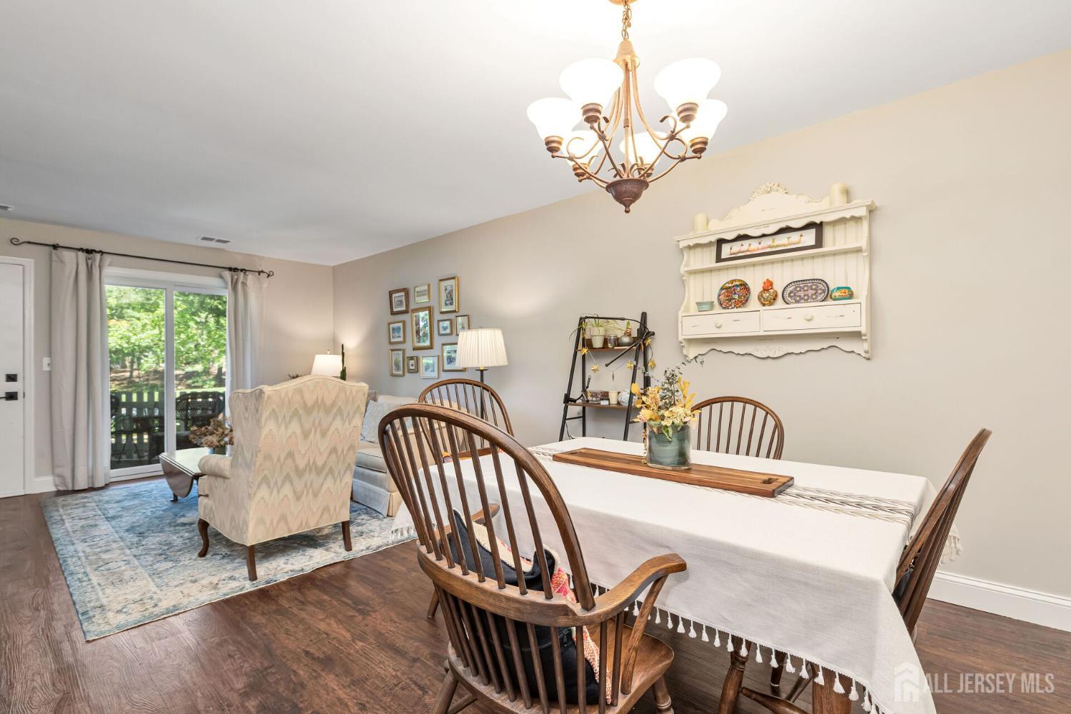29 Tansy Court Bedminster, NJ 07921 - Photo 4 of 11 a view of a dining room with furniture a chandelier and wooden floor