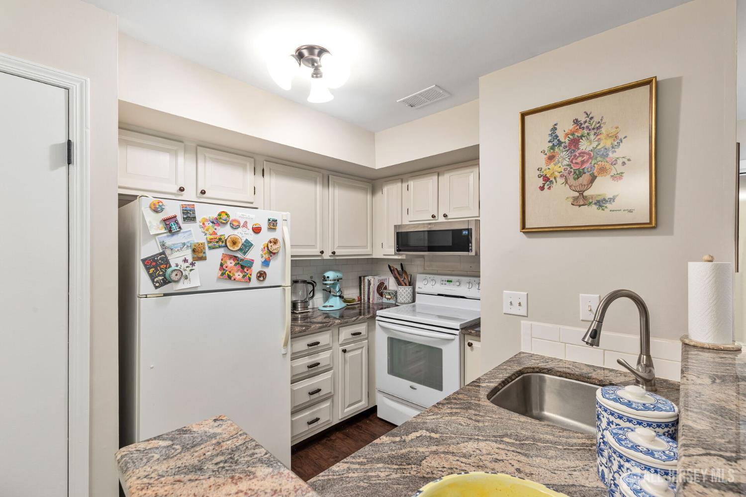 29 Tansy Court Bedminster, NJ 07921 - Photo 5 of 11 a kitchen with stainless steel appliances kitchen island granite countertop a refrigerator and a sink