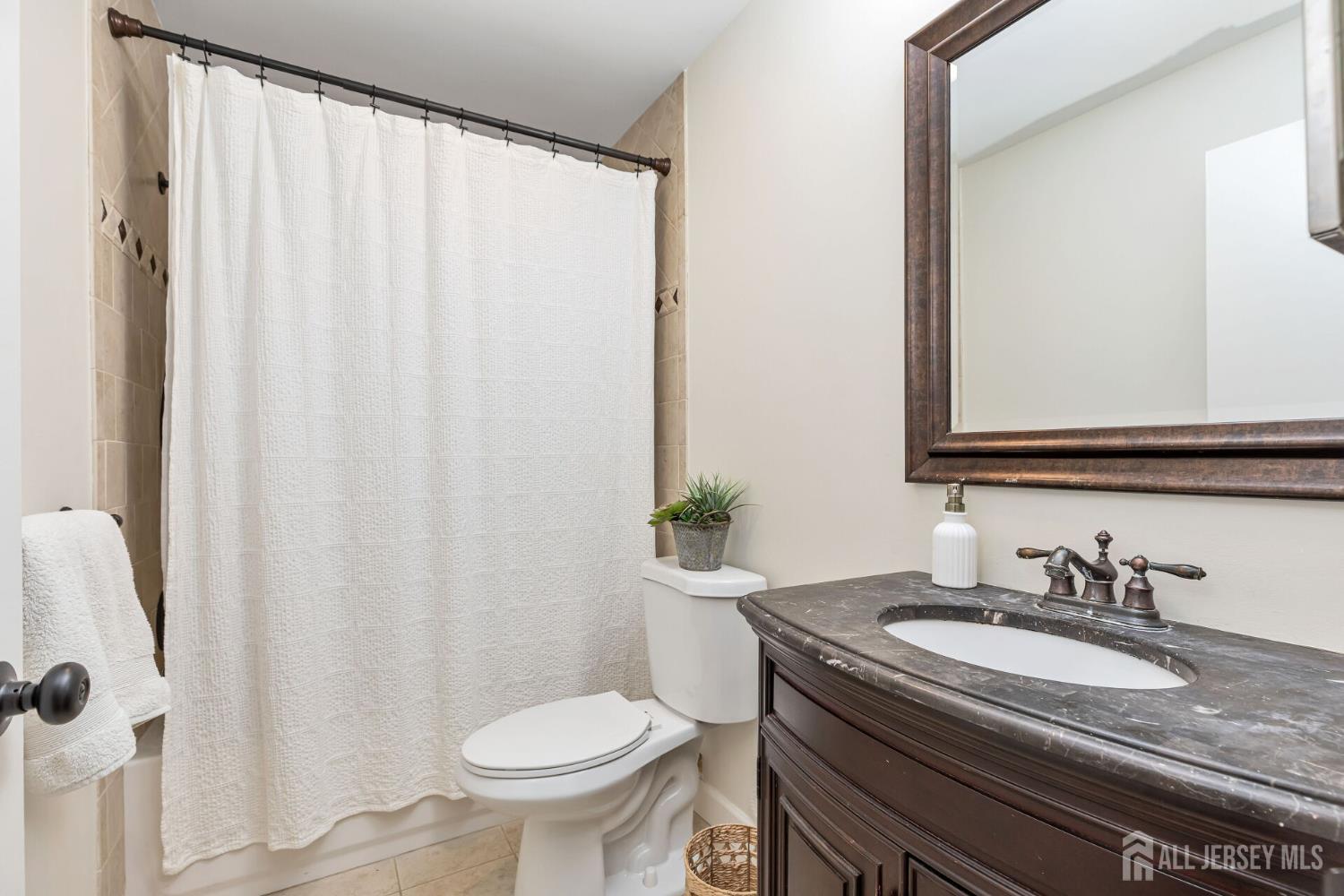 29 Tansy Court Bedminster, NJ 07921 - Photo 8 of 11 a bathroom with a granite countertop sink and a mirror