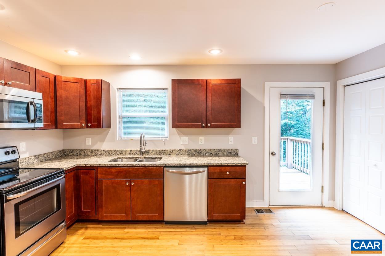 45 East Point Road Palmyra, VA 22963 - Photo 29 of 55 a kitchen with stainless steel appliances granite countertop a sink stove and cabinets