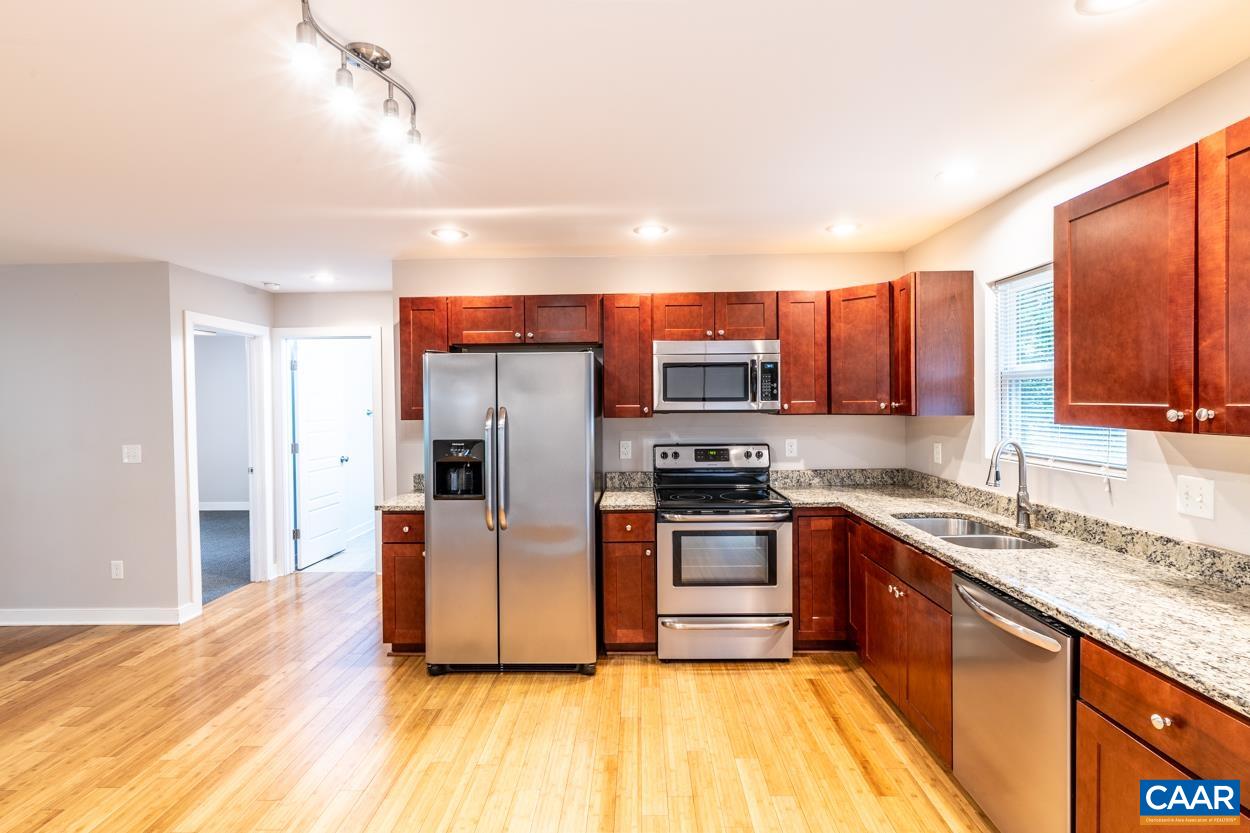 45 East Point Road Palmyra, VA 22963 - Photo 30 of 55 a kitchen with stainless steel appliances granite countertop a stove a sink dishwasher a refrigerator and a microwave oven with wooden floor