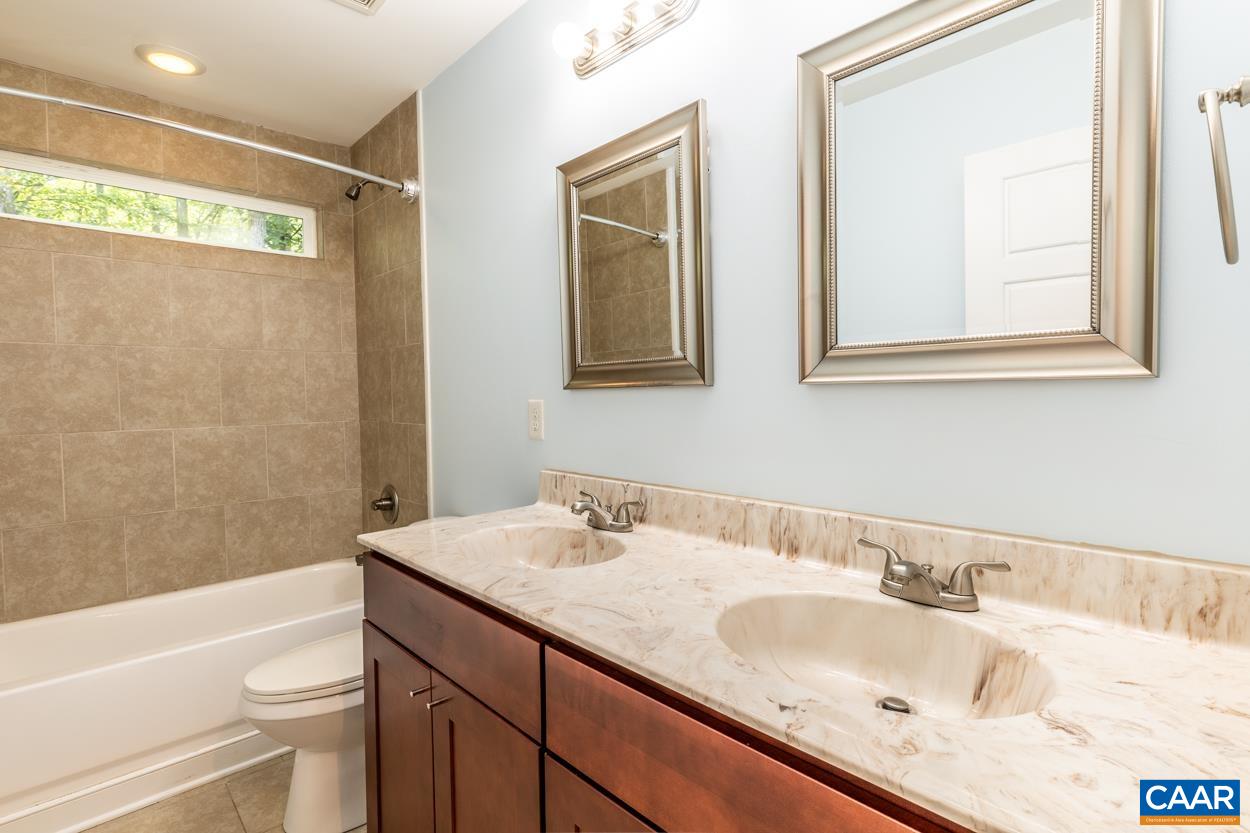 45 East Point Road Palmyra, VA 22963 - Photo 39 of 55 a bathroom with a granite countertop sink mirror vanity and toilet