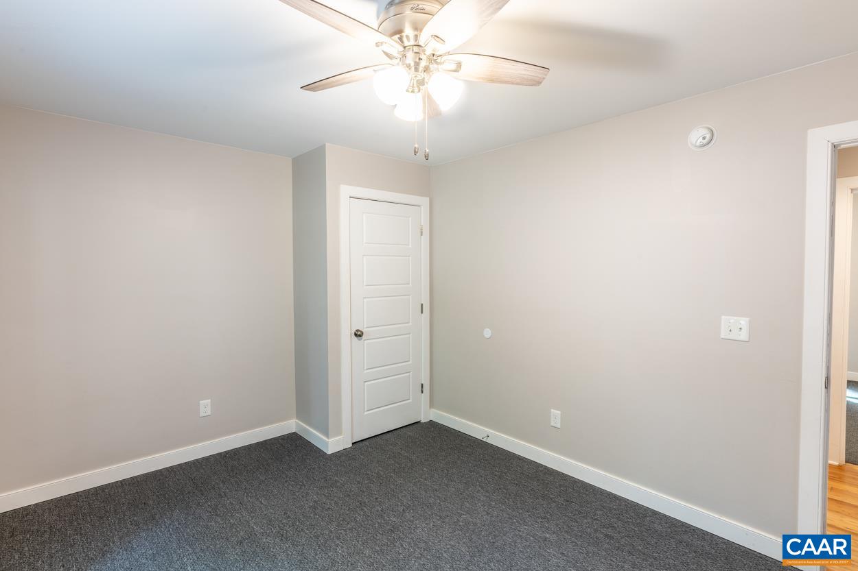 45 East Point Road Palmyra, VA 22963 - Photo 44 of 55 an empty room with a chandelier fan and closet area
