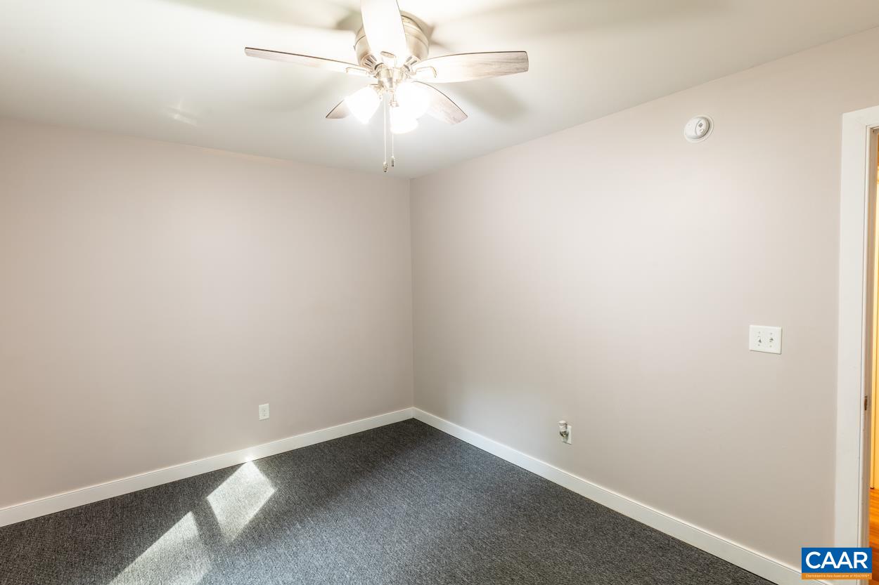 45 East Point Road Palmyra, VA 22963 - Photo 52 of 55 an empty room with a ceiling fan and wooden floor