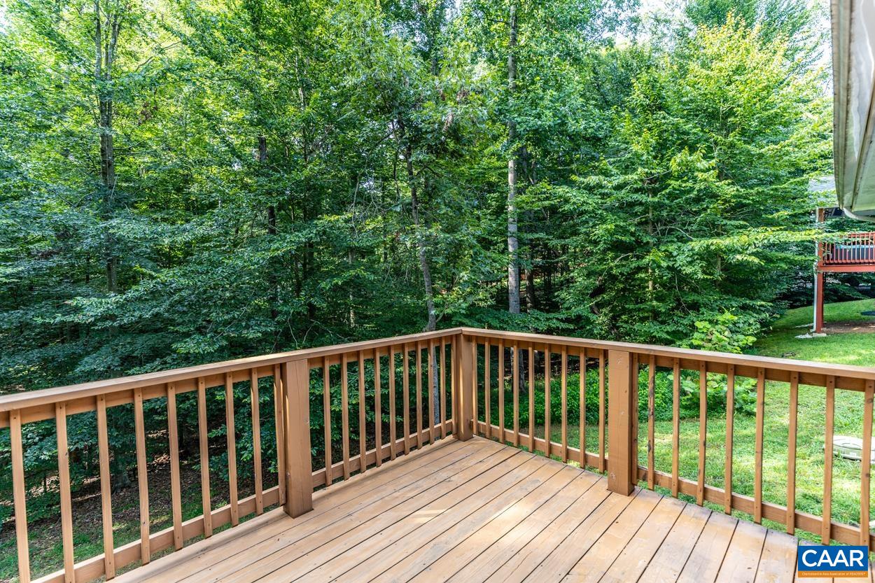 45 East Point Road Palmyra, VA 22963 - Photo 8 of 55 a wooden deck with trees in front of it