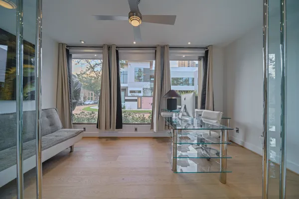 a living room with furniture and large windows