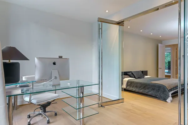 a living room with a bed furniture and a flat screen tv