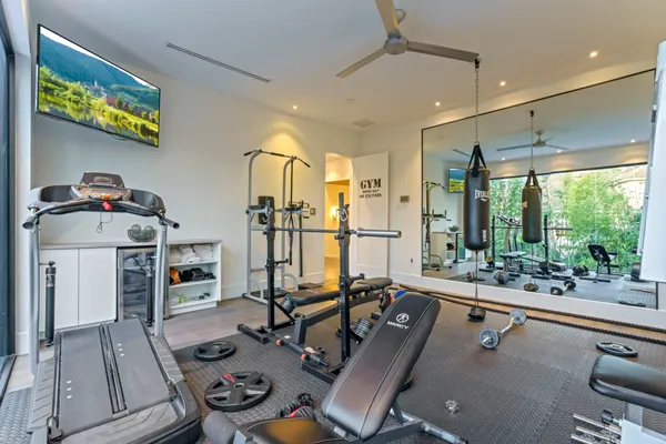 a room with furniture pool table and glass windows