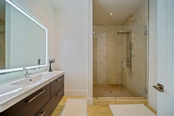 a bathroom with a shower and a sink