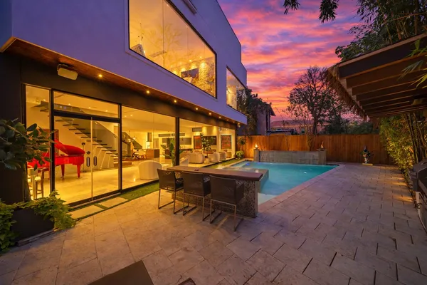 a backyard of a house with outdoor seating