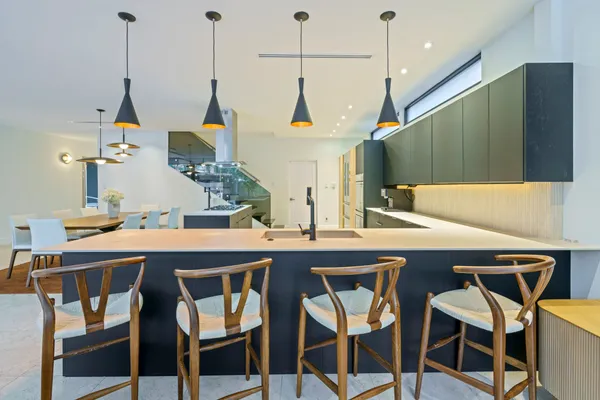 a kitchen island with a sink and cabinets