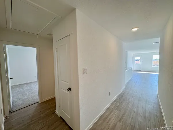a view of hallway with wooden floor