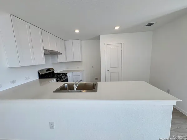 a kitchen with a sink cabinets and window