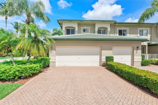 a front view of a house with a yard and a garage