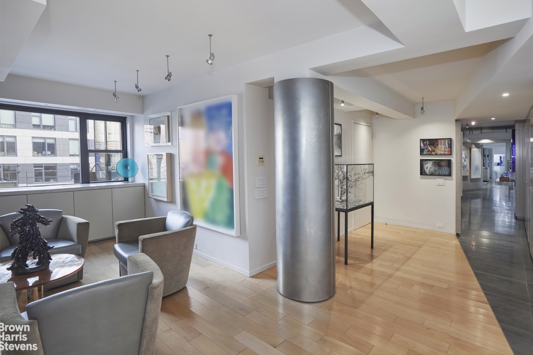 510 East 86th Street, Unit 17C Manhattan, NY 10028 - Photo 11 of 17 a living room with furniture a dining table and a refrigerator