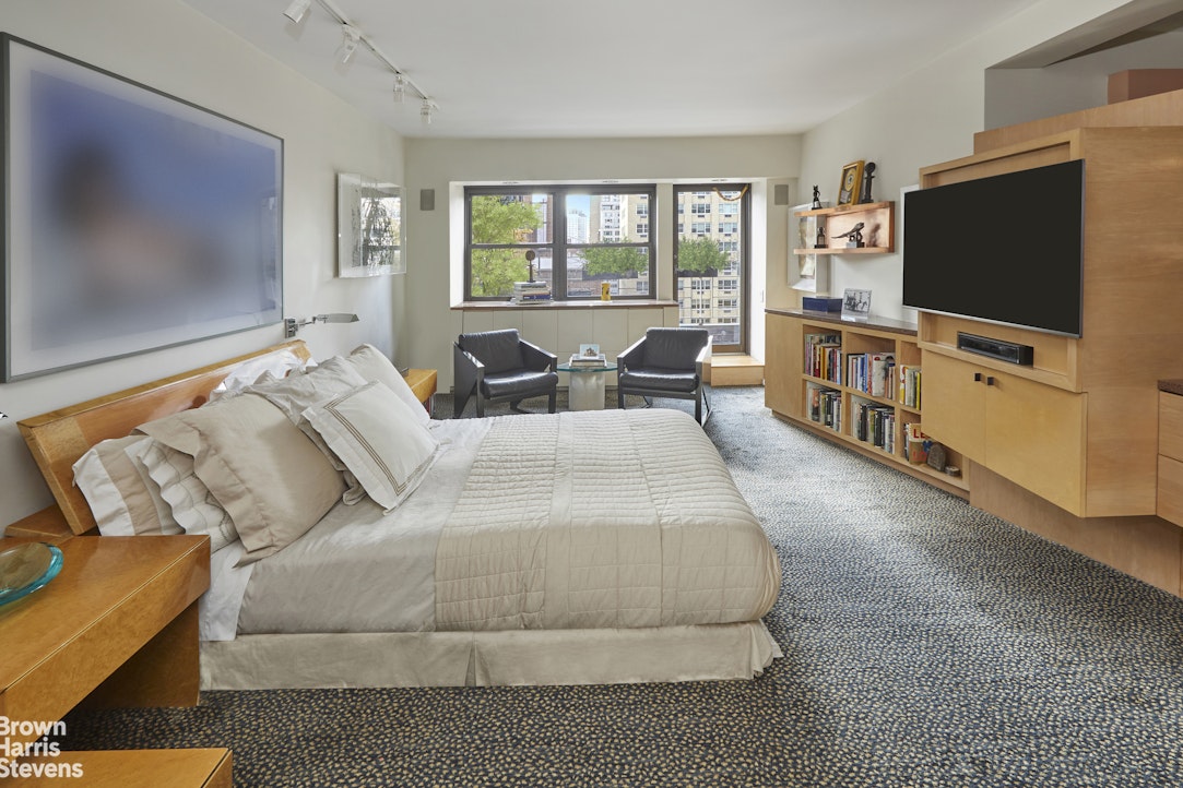 510 East 86th Street, Unit 17C Manhattan, NY 10028 - Photo 12 of 17 a living room with furniture and a flat screen tv