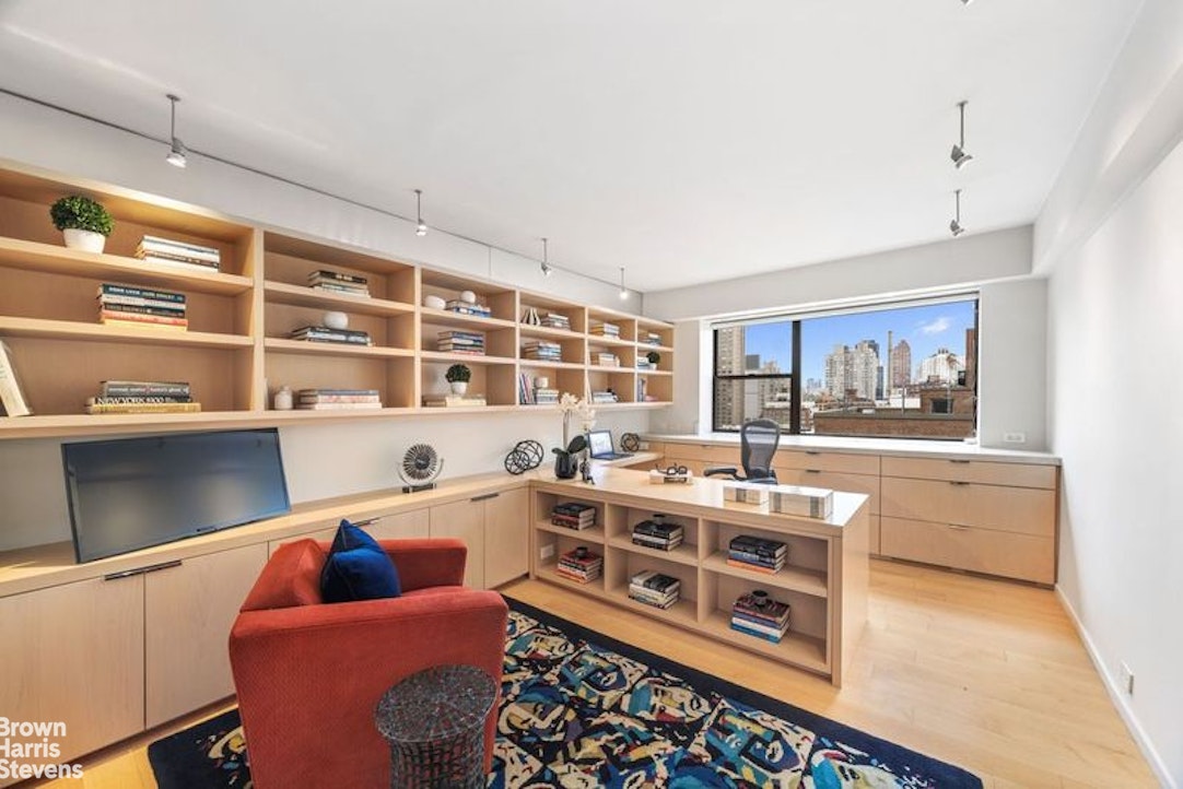 510 East 86th Street, Unit 17C Manhattan, NY 10028 - Photo 13 of 17 a living room with furniture and a baby crib