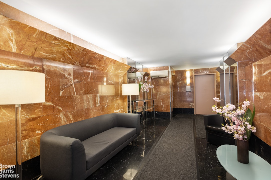 510 East 86th Street, Unit 17C Manhattan, NY 10028 - Photo 14 of 17 a living room with furniture and a large window